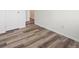 A view of a bedroom floor and wall, showing the laminate flooring and white doors at 9697 Marmot Ridge Cir, Littleton, CO 80125