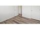 This is a bedroom with brown laminate wood flooring and white walls and doors at 9697 Marmot Ridge Cir, Littleton, CO 80125