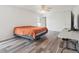Spacious bedroom featuring a ceiling fan, large windows, and wood floors at 9697 Marmot Ridge Cir, Littleton, CO 80125
