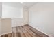 This bonus room has gray-brown laminate wood floors, white walls and good lighting at 9697 Marmot Ridge Cir, Littleton, CO 80125