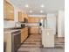 Modern kitchen with stainless steel appliances, island, and wood cabinets at 9697 Marmot Ridge Cir, Littleton, CO 80125