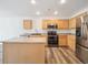 Modern kitchen featuring stainless steel appliances, ample cabinets, and a functional kitchen island at 9697 Marmot Ridge Cir, Littleton, CO 80125