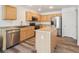 Modern kitchen featuring stainless steel appliances, ample cabinets, and a functional kitchen island at 9697 Marmot Ridge Cir, Littleton, CO 80125