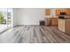 Open-concept kitchen and living area with hardwood floors for seamless entertaining at 9697 Marmot Ridge Cir, Littleton, CO 80125