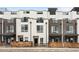Modern townhome exterior featuring sleek lines, a mix of brick and siding, and private balconies at 3520 W Connejos Pl # 5, Denver, CO 80204