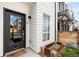 Charming front door with modern design, complemented by neat landscaping and exterior details at 3520 W Connejos Pl # 5, Denver, CO 80204