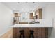 Contemporary kitchen with stainless steel appliances, a breakfast bar and natural wood cabinetry at 3520 W Connejos Pl # 5, Denver, CO 80204