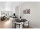 Bright, open concept living and dining area featuring modern decor and wood floors at 3520 W Connejos Pl # 5, Denver, CO 80204