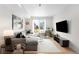 Cozy living room with a large window, modern decor, and a comfortable sectional sofa at 3520 W Connejos Pl # 5, Denver, CO 80204