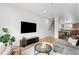Spacious living room with hardwood floors, modern furnishings, and an open floor plan at 3520 W Connejos Pl # 5, Denver, CO 80204