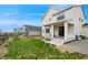 Spacious backyard featuring green grass, a patio, and a view of neighboring houses at 1143 Williams Loop, Elizabeth, CO 80107