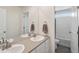 Bathroom with double sinks, a large mirror, and a separate shower and toilet area at 1143 Williams Loop, Elizabeth, CO 80107