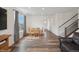 Open-concept dining area featuring hardwood floors, a natural wood table, and plenty of natural light at 1143 Williams Loop, Elizabeth, CO 80107