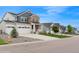 Exterior view showcasing the house, its three-car garage, well-kept lawn, and neighborhood at 1143 Williams Loop, Elizabeth, CO 80107
