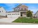 Charming two-story home showcasing a stone and siding facade with a three-car garage and manicured lawn at 1143 Williams Loop, Elizabeth, CO 80107