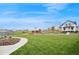Expansive lawn framing a picturesque home with a historic windmill, evoking a sense of tranquility and charm at 1143 Williams Loop, Elizabeth, CO 80107