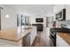 Spacious kitchen features granite counters, stainless appliances, and flows into the living room at 1143 Williams Loop, Elizabeth, CO 80107
