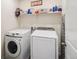 Functional laundry room with modern appliances and overhead storage shelf at 1143 Williams Loop, Elizabeth, CO 80107