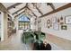 Upscale lounge area with vaulted ceilings, exposed beams, designer lighting, and comfortable green seating at 1143 Williams Loop, Elizabeth, CO 80107