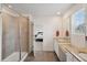 Bright bathroom with double sinks, granite countertops, and glass shower with tile surround at 1143 Williams Loop, Elizabeth, CO 80107