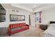 Sitting area in the main bedroom with carpeting, tray ceiling, and colorful curtains at 1143 Williams Loop, Elizabeth, CO 80107