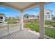 Covered front porch with a view of the well-maintained lawn, wooden fence and neighborhood at 1143 Williams Loop, Elizabeth, CO 80107
