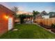 Spacious backyard featuring a lush lawn, garden beds, and outdoor storage at 534 S Pearl St, Denver, CO 80209