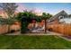 Large backyard with deck, dining area, lounge chairs, and lush greenery at 534 S Pearl St, Denver, CO 80209