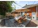 Relaxing backyard deck with lounge chairs, dining set, and shady umbrella at 534 S Pearl St, Denver, CO 80209