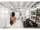 Finished basement with a living area featuring modern furniture, carpet, and bright lighting at 534 S Pearl St, Denver, CO 80209