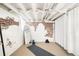 Finished basement area perfect for yoga with exposed brick, white painted ceiling and neutral carpet at 534 S Pearl St, Denver, CO 80209