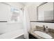 Traditional bathroom featuring a soaking tub, white tiled walls, vanity with granite countertop, and shower at 534 S Pearl St, Denver, CO 80209