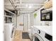 Bathroom and laundry area with modern washer/dryer, walk-in shower and a charming design at 534 S Pearl St, Denver, CO 80209