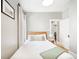 Bright bedroom features a wood bed frame, neutral walls, hardwood floors and a charming decor at 534 S Pearl St, Denver, CO 80209