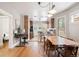 Open dining area flows into a modern kitchen with hardwood floors and ample seating at 534 S Pearl St, Denver, CO 80209
