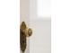 Close up of ornate vintage brass doorknob with decorative detailing on a white door at 534 S Pearl St, Denver, CO 80209