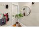 Cozy entryway with coat hooks, a round mirror, and a decorative plant adding a touch of nature at 534 S Pearl St, Denver, CO 80209