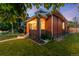 Charming brick home with a well-manicured lawn and inviting front porch at dusk at 534 S Pearl St, Denver, CO 80209