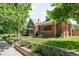 Charming brick home featuring a well-kept front lawn and beautiful landscaping in a desirable neighborhood at 534 S Pearl St, Denver, CO 80209