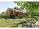 Charming home with lush green lawn, mature trees, and classic brick facade in a desirable location at 534 S Pearl St, Denver, CO 80209