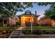 Charming brick home with a cozy front porch and well-maintained lawn at dusk at 534 S Pearl St, Denver, CO 80209