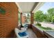 Charming front porch with red brick, seating and view of tree-lined street at 534 S Pearl St, Denver, CO 80209