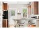 Kitchen with granite counters, modern stainless steel appliances, wooden cabinets, and breakfast bar at 534 S Pearl St, Denver, CO 80209