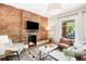 Stylish living room with exposed brick fireplace, comfortable seating, and a bright window view at 534 S Pearl St, Denver, CO 80209