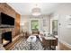 Inviting living room with brick fireplace, plush seating, and natural light from a nearby window at 534 S Pearl St, Denver, CO 80209