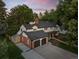 An aerial view captures this two-story home with mature trees and a well-maintained lawn and attached garage at 2684 Taft Ct, Lakewood, CO 80215