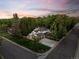 This aerial shot shows the property on a large corner lot with mature trees providing privacy and shade at 2684 Taft Ct, Lakewood, CO 80215