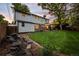 Lush backyard view featuring well-maintained lawn, mature trees, and inviting outdoor spaces at 2684 Taft Ct, Lakewood, CO 80215