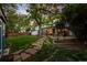 Expansive backyard showcasing a stone pathway, lush landscaping, and inviting outdoor spaces at 2684 Taft Ct, Lakewood, CO 80215