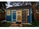 Charming backyard shed with unique door design, adding character to the outdoor space at 2684 Taft Ct, Lakewood, CO 80215